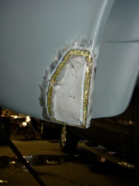 Trailing edge of passenger rear wheel well